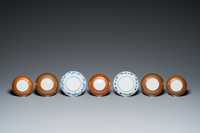 Eleven Chinese blue and white saucers, seven cups and a bowl, Kangxi/Qianlong