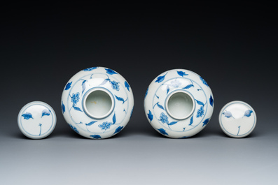 A pair of small Chinese blue and white covered vases on wooden stands, Xuande mark, 19/20th C.