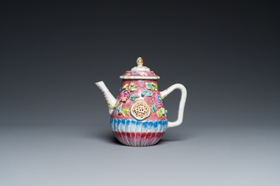 A Chinese famille rose relief-decorated teapot and cover on stand, Yongzheng