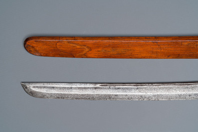 An Indonesian sword in wooden scabbard, dated 1891 and inscribed TJIPATJING