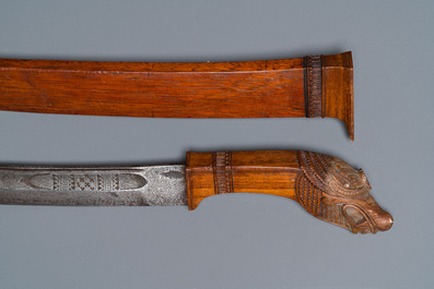 An Indonesian sword in wooden scabbard, dated 1891 and inscribed TJIPATJING