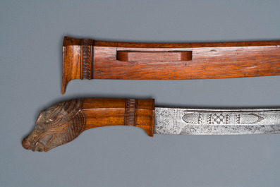 An Indonesian sword in wooden scabbard, dated 1891 and inscribed TJIPATJING