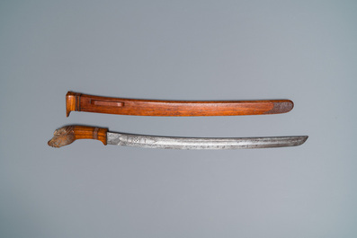 An Indonesian sword in wooden scabbard, dated 1891 and inscribed TJIPATJING