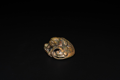A Chinese gilt bronze &lsquo;dog&rsquo; scroll weight, Ming