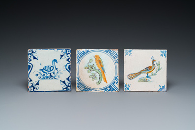 Two polychrome Dutch Delft tiles with a parrot and a peacock, and a blue and white one with a goose, 17th C.