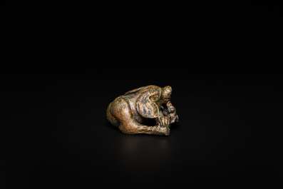 A Chinese gilt bronze &lsquo;dog&rsquo; scroll weight, Ming