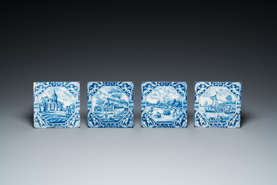 Four blue and white Dutch Delft tiles with fine landscapes and cherubs as corner motives, 18th C.