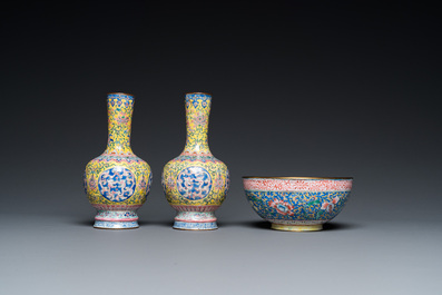 A pair of Chinese yellow-ground Canton enamel vases and a bowl, Yongzheng/Qianlong