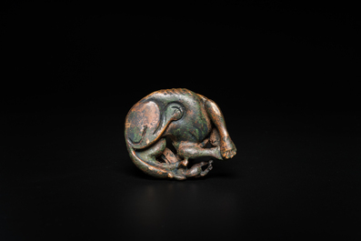 A Chinese gilt bronze &lsquo;dog&rsquo; scroll weight, Ming