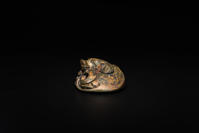 A Chinese gilt bronze &lsquo;dog&rsquo; scroll weight, Ming