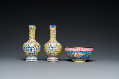 A pair of Chinese yellow-ground Canton enamel vases and a bowl, Yongzheng/Qianlong