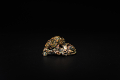 A Chinese gilt bronze &lsquo;dog&rsquo; scroll weight, Ming