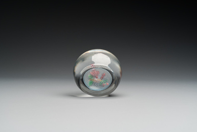 A glass Saint Louis paperweight with fuchsia on a latticinio-ground, ca. 1850