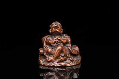 A Chinese bamboo carving of a laughing Luohan, 18th C.