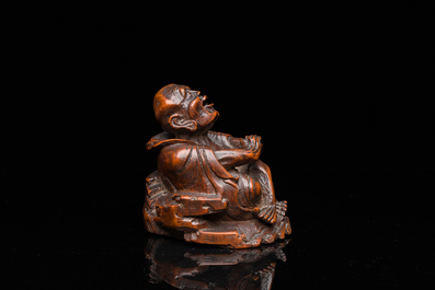 A Chinese bamboo carving of a laughing Luohan, 18th C.