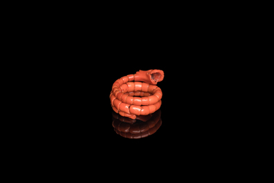 A Chinese red coral bracelet with a dragon's or snake's head, 19th C.