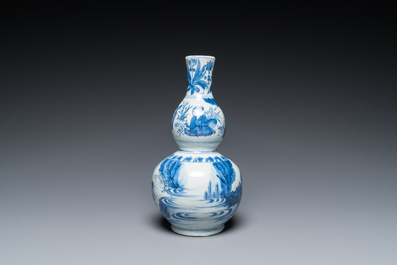 A Chinese blue and white double gourd vase with figures in a landscape, Transitional period