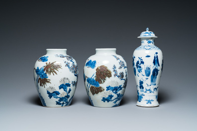 A pair of Chinese blue, white and copper-red vases, a blue and white covered vase and a Canton famille rose box and cover, 19/20th C.
