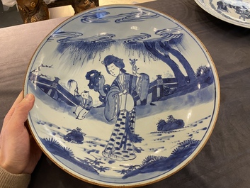 A large Chinese blue and white 'lady and boy' dish, Kangxi mark and of the period