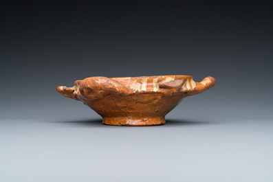 A slip-decorated three-handled earthenware bowl, probably Germany, 16/17th C.