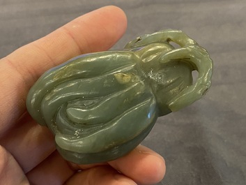 A Chinese white jade snuff bottle and a green jade 'Buddha hand' pendant, Qing