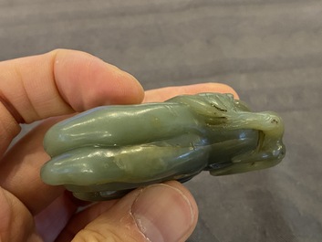 A Chinese white jade snuff bottle and a green jade 'Buddha hand' pendant, Qing