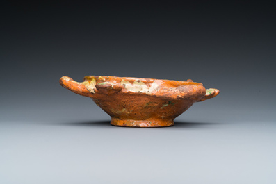 A slip-decorated three-handled earthenware bowl, probably Germany, 16/17th C.