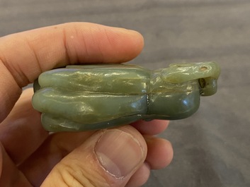 A Chinese white jade snuff bottle and a green jade 'Buddha hand' pendant, Qing