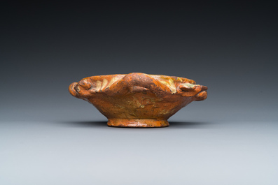 A slip-decorated three-handled earthenware bowl, probably Germany, 16/17th C.