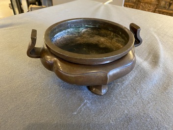 A Chinese lotus-shaped bronze tripod censer, late Ming or early Qing