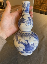 A Chinese blue and white double gourd vase with figures in a landscape, Transitional period