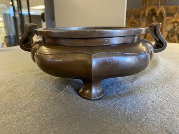 A Chinese lotus-shaped bronze tripod censer, late Ming or early Qing