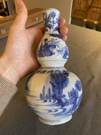 A Chinese blue and white double gourd vase with figures in a landscape, Transitional period