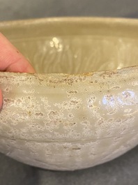 A Vietnamese pale green-glazed bowl with incised lotus decoration, early 15th C.