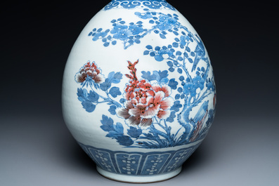 A Chinese blue, white and copper-red bottle vase with a deer and birds among blossoming branches, 19th C.