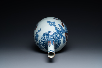 A Chinese blue, white and copper-red bottle vase with a deer and birds among blossoming branches, 19th C.