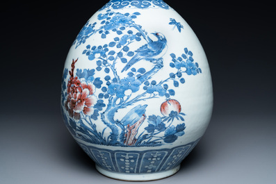 A Chinese blue, white and copper-red bottle vase with a deer and birds among blossoming branches, 19th C.