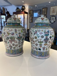 A pair of Chinese famille rose 'antiquities' vases and covers, 19th C.