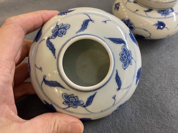 A pair of small Chinese blue and white covered vases on wooden stands, Xuande mark, 19/20th C.