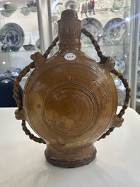 Two German stoneware bellarmine jugs and a pilgrim's flask, 17th C.