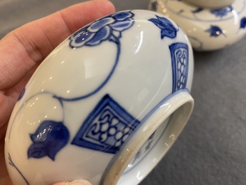 A pair of small Chinese blue and white covered vases on wooden stands, Xuande mark, 19/20th C.