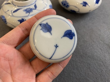 A pair of small Chinese blue and white covered vases on wooden stands, Xuande mark, 19/20th C.