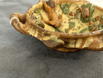 A slip-decorated three-handled earthenware bowl, probably Germany, 16/17th C.