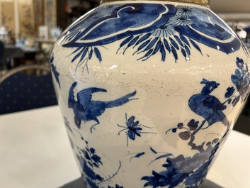 Two Dutch Delft blue and white vases with birds near blossoming branches, 18th C.