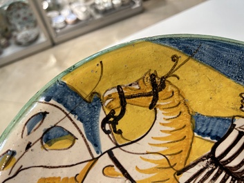 A polychrome Italian maiolica dish with a horserider, Montelupo, 17th C.