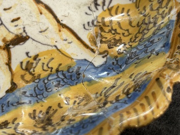 A small polychrome maiolica dish with a fighting putto, Verstraeten workshop, Haarlem, 17th C.