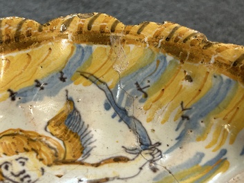 A small polychrome maiolica dish with a fighting putto, Verstraeten workshop, Haarlem, 17th C.