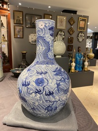 A Chinese blue and white 'dragons' bottle vase, 19th C.