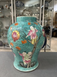 A Chinese turquoise-ground famille rose 'boys at a pomegranate tree' vase and cover, 19th C.
