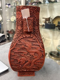 A Chinese red cinnabar lacquer 'fanghu' vase, 19/20th C.